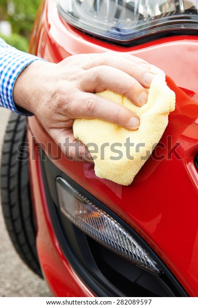 Close Up Of Hand\
Polishing Car Using Cloth