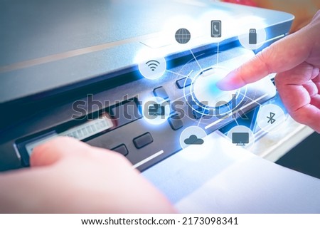 Close up of hand press button on panel of printer with icon function of printer in the home office. Technology of printer concept.