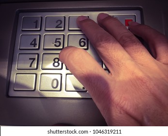 Close up hand Press the code from the atm cabinet Focus light on numbers and finger space for text vintage style.