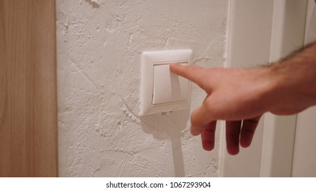 Close Up of Hand Pressing Button to Switch on the Light