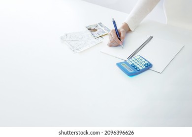 Close up of hand to record receipt in housekeeping book account book - Shutterstock ID 2096396626