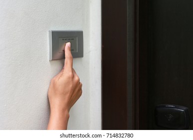 Close Up Of Hand Ringing Doorbell.