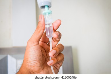 Close up hand and  saline solution drip for patient