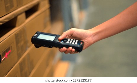 Close up hand scanning products with barcode scanner in warehouse. - Powered by Shutterstock