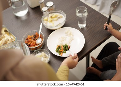 Close Up Of Hand Serving Some Food For Early Breakfast Before Dawn