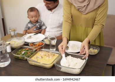 Close Up Of Hand Serving Some Food For Early Breakfast Before Dawn