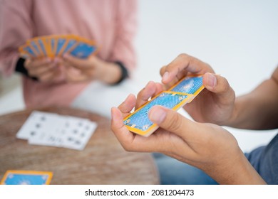 Close Up Of A Hand Shuffling Cards While Playing Cards