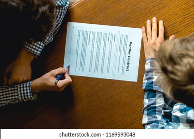 Close Up Hand Sign Vendor Contract On The Table For The New House, Concept