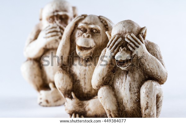 close up of hand small statues\
with the concept of see no evil, hear no evil and speak no\
evil.