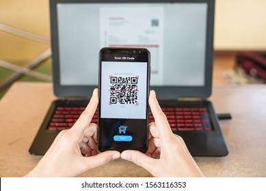 Close up of hand smartphone to make mobile wallet payment via QR code scanning digital invoice from laptop screen. The QR code leads to "Thank you so much" when scanned.