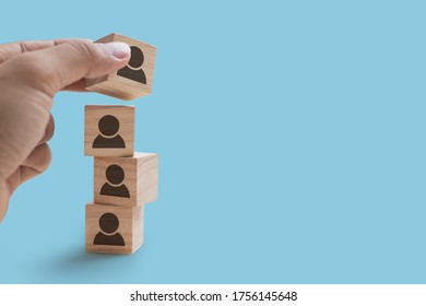Close up of hand is stacking wooden blocks icons people, Strategy concept and the copy space on blue background - Shutterstock ID 1756145648
