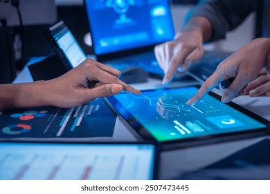 close up hand team of financial discussion fintech  technology planning, analyzing digital financial data and strategy in a modern office at night - Powered by Shutterstock