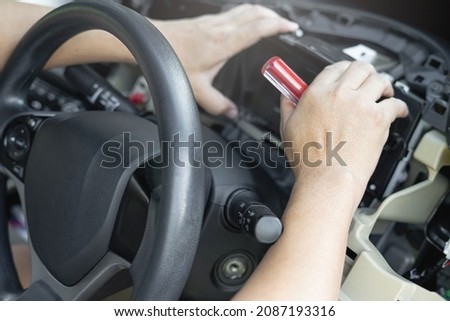 Close up hand Technician remove car speedometer with screw driver in side cabin check and Replace new parts to replace the broken in car service shop