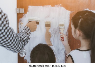 Close Up Hand Of Teen Girls And Family Her Holding A Roller And Painting The Walls While Renovating The New Room Or House On Weekend. Concept Of Interiors Renovating Or Moving, Construction Work