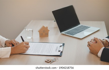 Close Up Hand Of Tenant, Client Woman Use The Pen For Sign Signature Contract Rental House, Apartment On Paperwork After A Successful Agreement With Landlord Or Realtor.