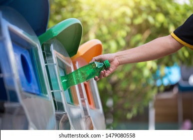 Close Up Hand Throwing Empty Plastic Bottle Into The Trash, Recycling Concept