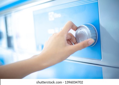 Close Up Hand Is Turning Dial Knob Of Laundry Washing Machine.