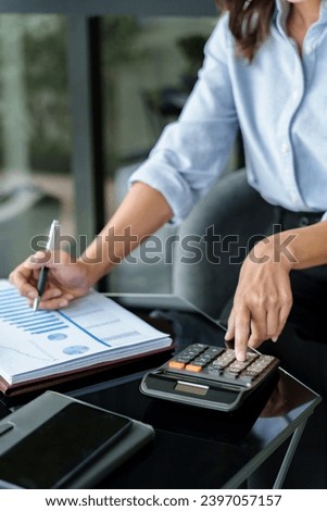 Close up of hand using calculator calculating personal finance for income and expenses.