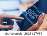 Close up of hand using digital tablet with creative blockchain hologram on blurry wooden office desktop background. Cryptocurrency and finance concept. Double exposure