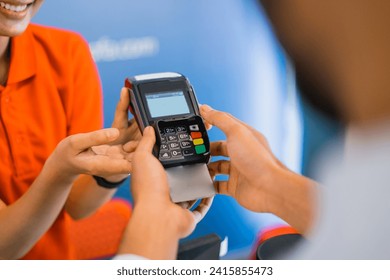close up of a hand using an EDC tool for payment using a credit card