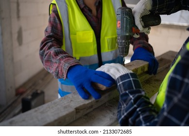 Close Up To Hand Using An Electric Screwdriver And Wearing Personal Protective Equipment.
Worker Wear Gloves,PPE Work Safe Concept.Prevention Concept.Work Safe Concept.Construction No Harmful.