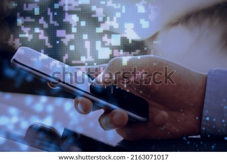 Close up of hand using mobile phone with digital metaverse pixel hologram on blurry background. Cyberspace concept. Double exposure