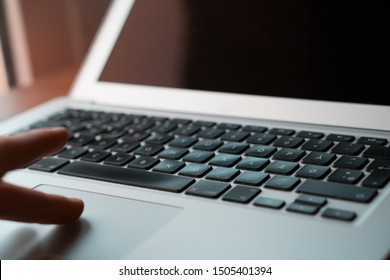 Close up hand using mousepad on laptop.