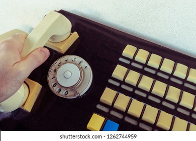 Close Up Hand Using Of The Retro Rotary Telephone. Wired Communications Equipment.  Old Telephone With Switchboard Operator. 