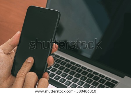 close up of hand using smart phone,laptop, online banking payment communication network technology 4.0,internet wireless application development sync app