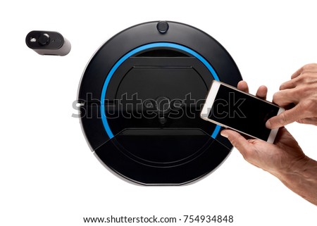 Close up of hand using smartphone to control robotic vacuum cleaner Stock photo © 