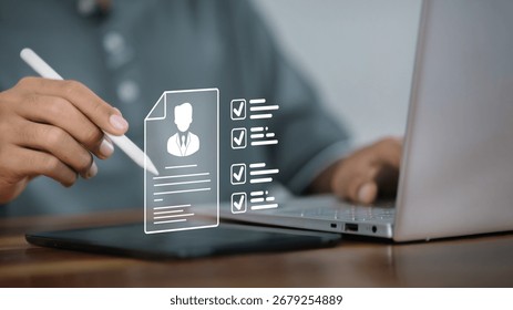 Close up hand using stylus with tablet showing resume checklist and laptop, recruitment, job application, HR technology, digital profile verification concept.