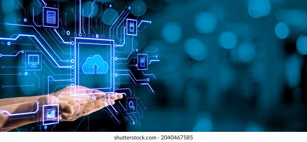 Close up of hand using tablet with abstract glowing circuit cloud computing interface on blurry blue bokeh background with mock up place. Information, technology and network concept