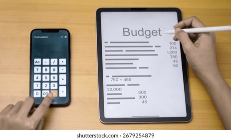 Close up hand using tablet for budget planning with smartphone calculator, personal finance, money management, financial planning, accounting, fintech technology concept.