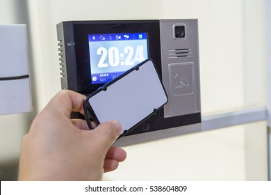 Close Up  Hand Using White Keycard To Open Door Access Control By Digital Access Control Lock And Have Digital Clock On Screen. Optional Function With Time Attendance Record. 