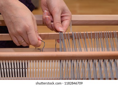 Close Up Of A Hand Warping A Rigid Heddle Loom