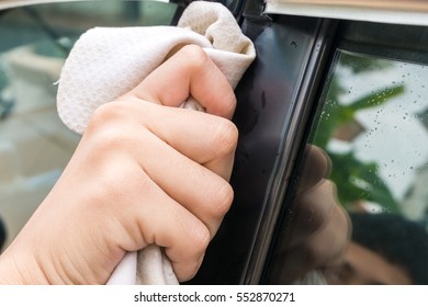 Close Up Of Hand Washing Car With Yellow Chamois (microfiber Towel)