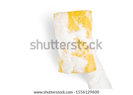 Close up of Hand is wearing the glove and holding a yellow sponge filled with bubbles on white background with clipping path.