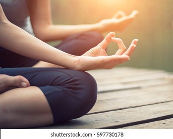 Close Up Hand. Woman Do Yoga Outdoor. Woman Exercising And Zen Relax And Relaxation Yoga At The Nature Background. Healthy And Lifestyle Concept

