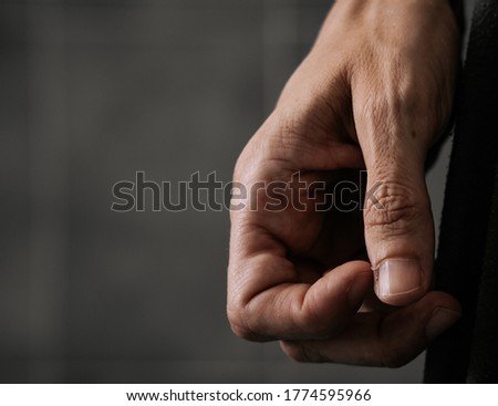 Close up of the hand of a woman who is nervously scratching a hangnail. Agitation concept.