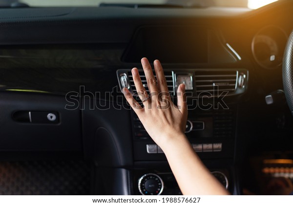 Close up\
of hand women checking flow cold from air conditioner in modern\
car,Cooling system in car,Auto air\
conditioning