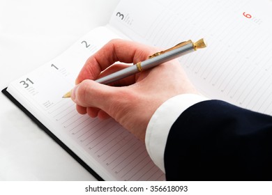 Close up of hand writing and notepad