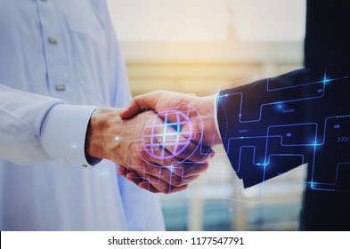 close up hand of young Arabian man in white suit handshake after finishing up meeting with graphic network diagram, partnership, teamwork, technology, connection, financial and investment concept