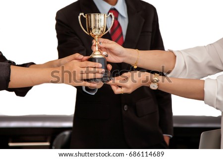 Close up of hand  A young businessman and business women  ,New Generation Businessmen holding a trophy,  Meeting Modern Room in office white background. Concept Teamwork.