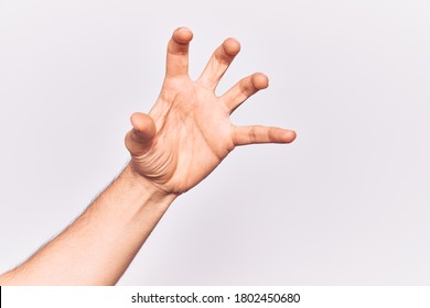 Close up of hand of young caucasian man over isolated background grasping aggressive and scary with fingers, violence and frustration  - Shutterstock ID 1802450680