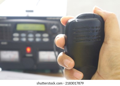 Close Up Of Handholding Speakerphone Radio Transceiver For Conversation.