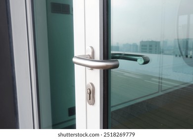 Close up handle and keys lock in glass door on aluminum frame - Powered by Shutterstock