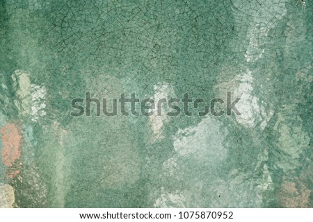 Close up handmade glazed pottery ceramic art texture surface, dark green. Reflection from smooth surface.  Abstract vintage, contemporary, antique style wallpaper background.