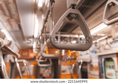 Close up of Handrail Ring inside metro train in Tokyo. Transportation safety concept