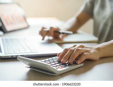 close up hands of accountant calculating tax refund using calculator