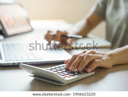 close up hands of accountant calculating tax refund using calculator Сток-фото © 